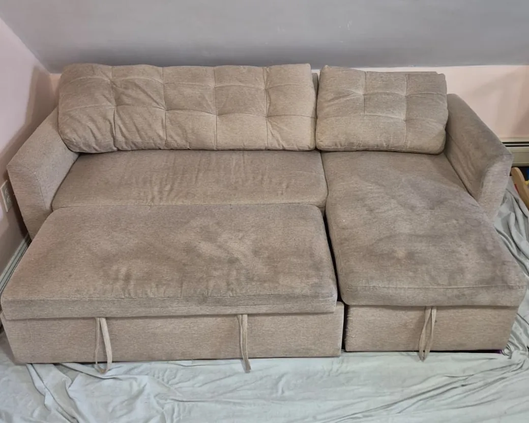 Beige sectional sleeper sofa before cleaning