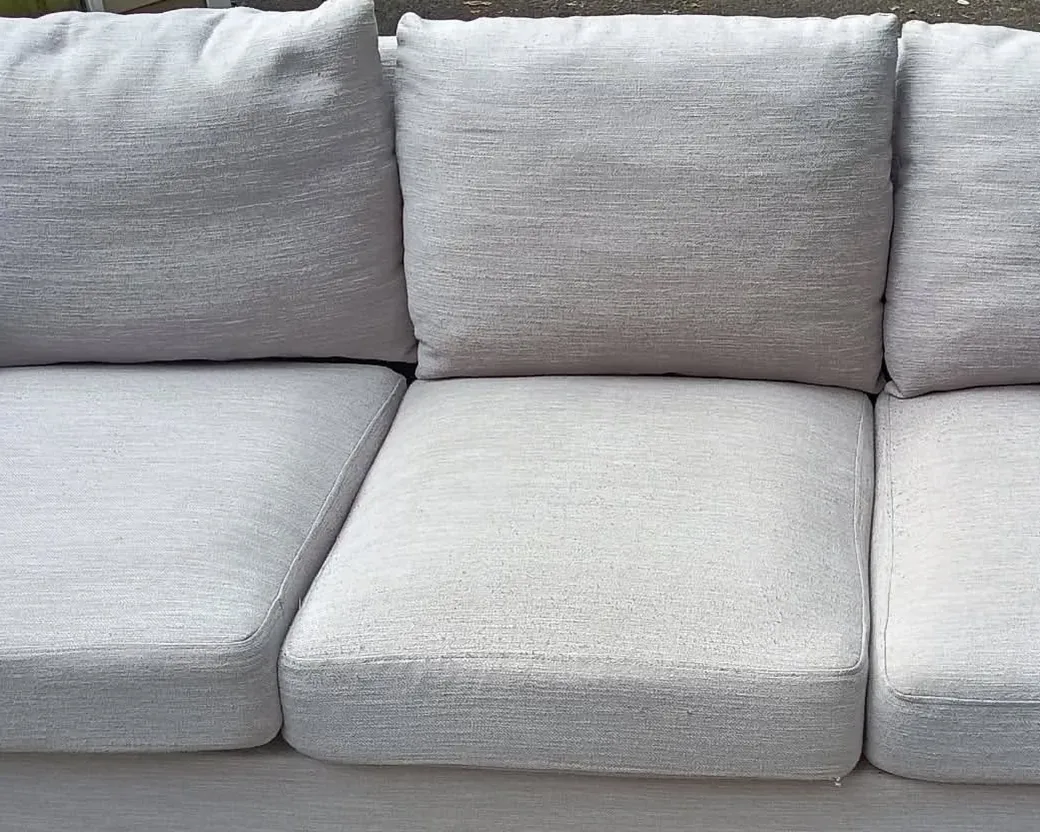 Light gray three seater sofa after cleaning