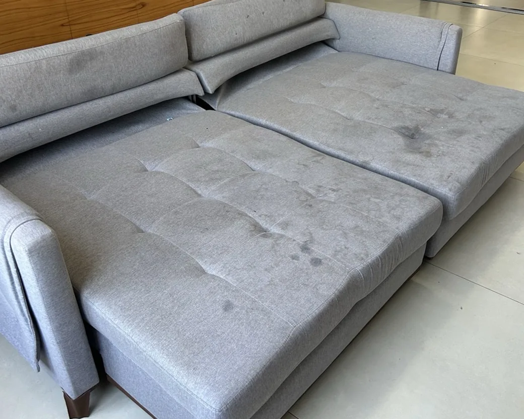 Gray sectional sofa bed before cleaning